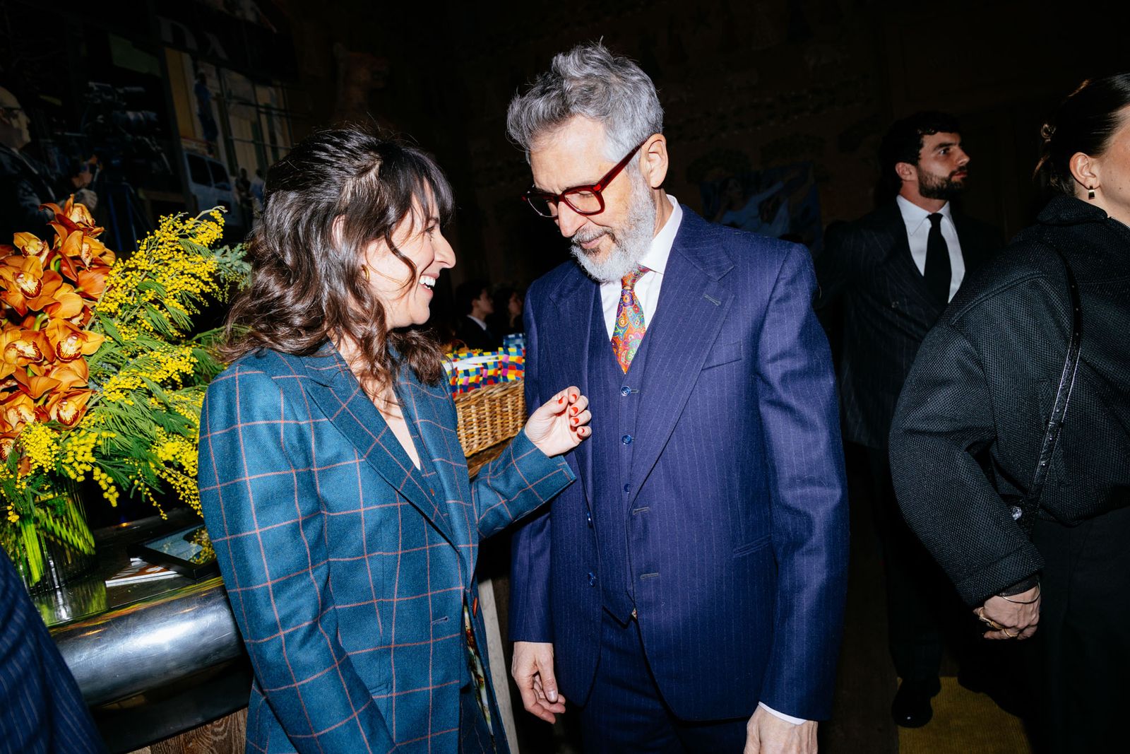 Image may contain Ira Glass Susanna Fogel Blazer Clothing Coat Jacket Formal Wear Suit Accessories Tie and People
