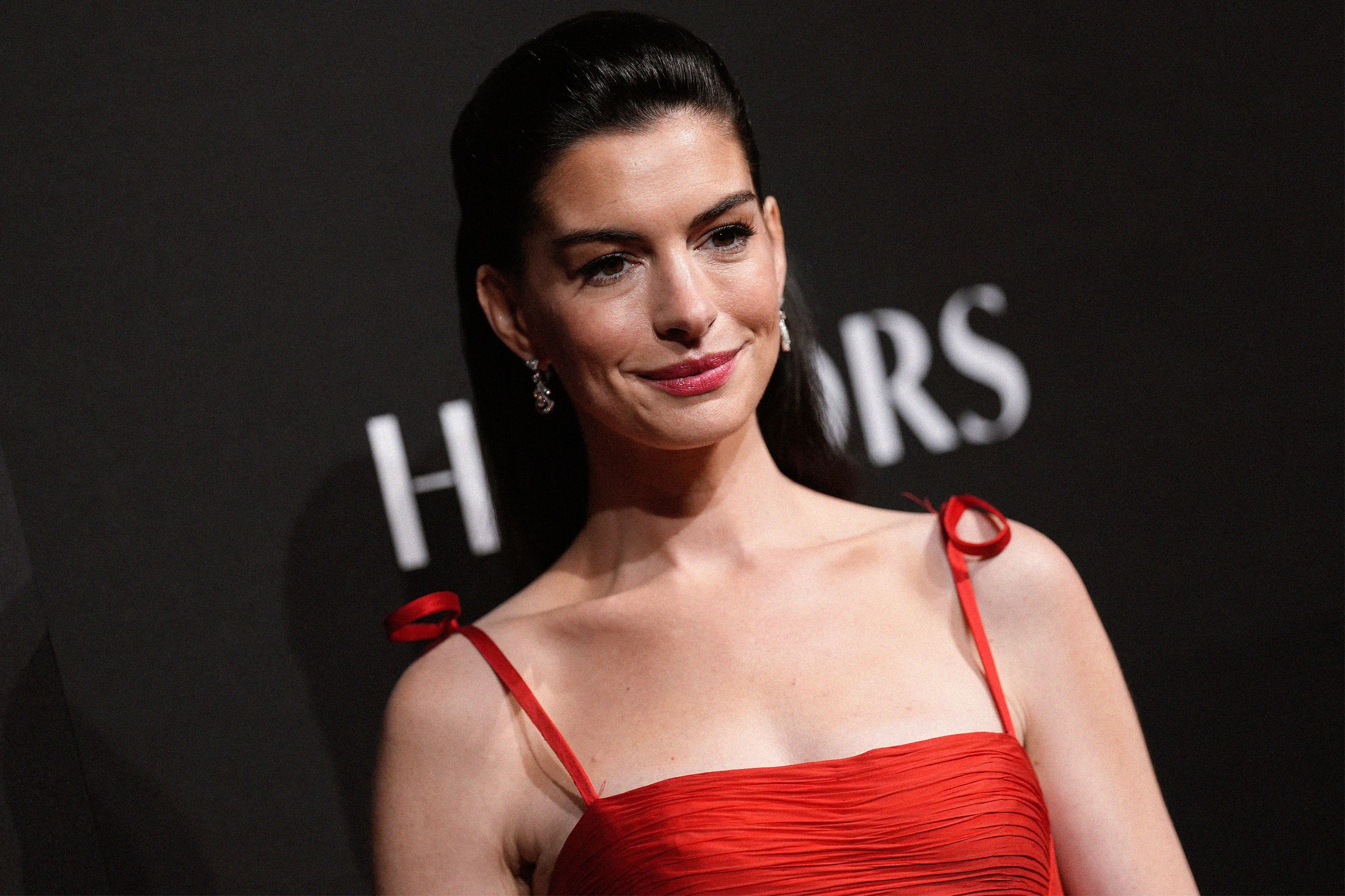 Image may contain Anne Hathaway Head Person Face Dimples Adult Happy Smile Black Hair and Hair